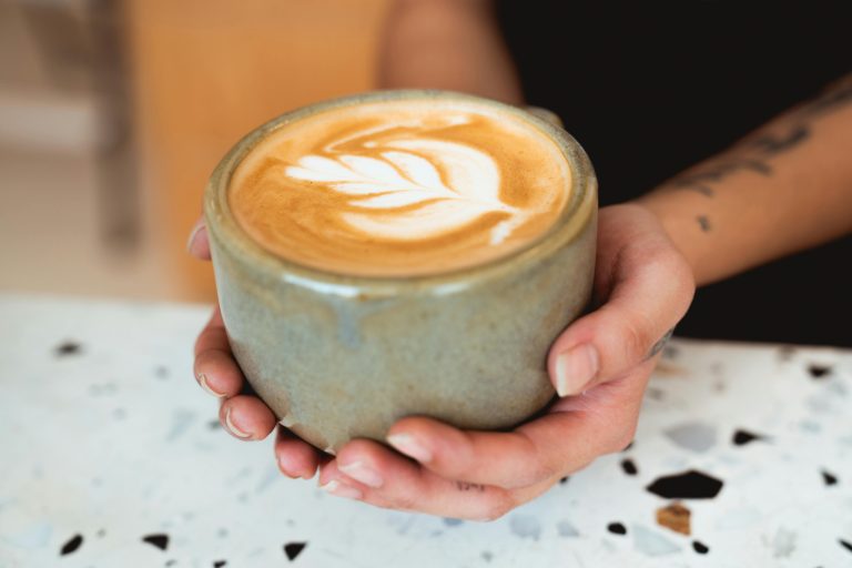 hands holding cup of coffee