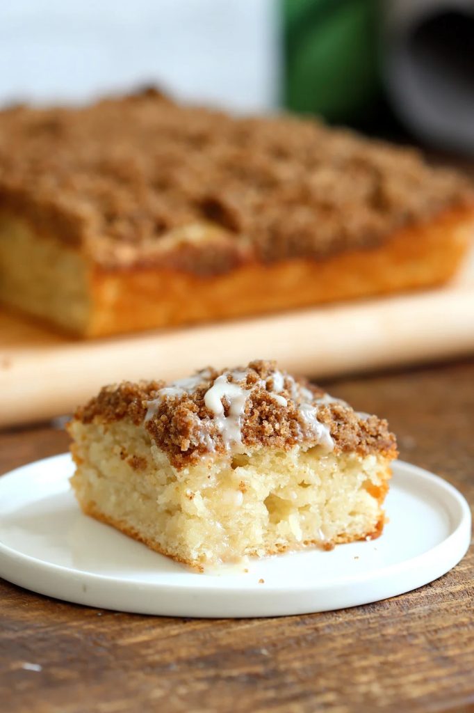 piece of coffee cake with larger cake in background