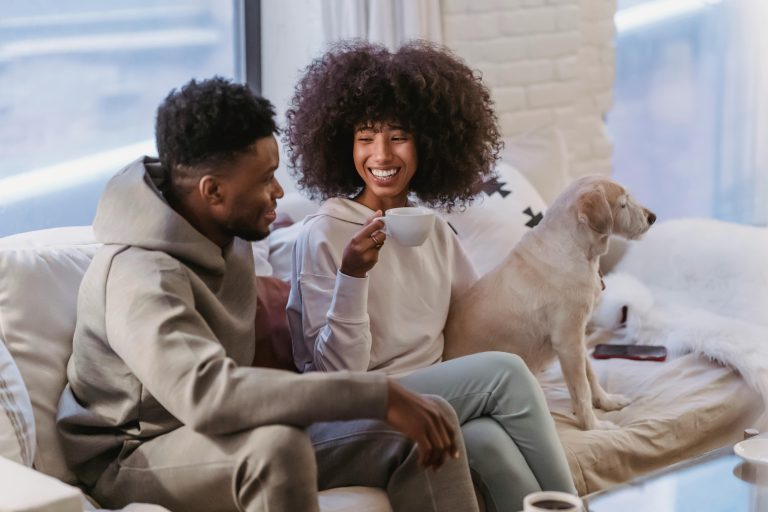woman with a cup of coffee smiling at a man