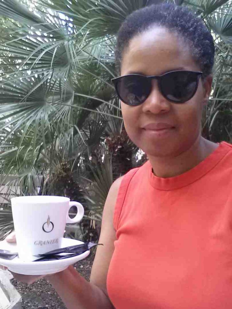 a woman holding a cup of coffee in Barcelona Spain