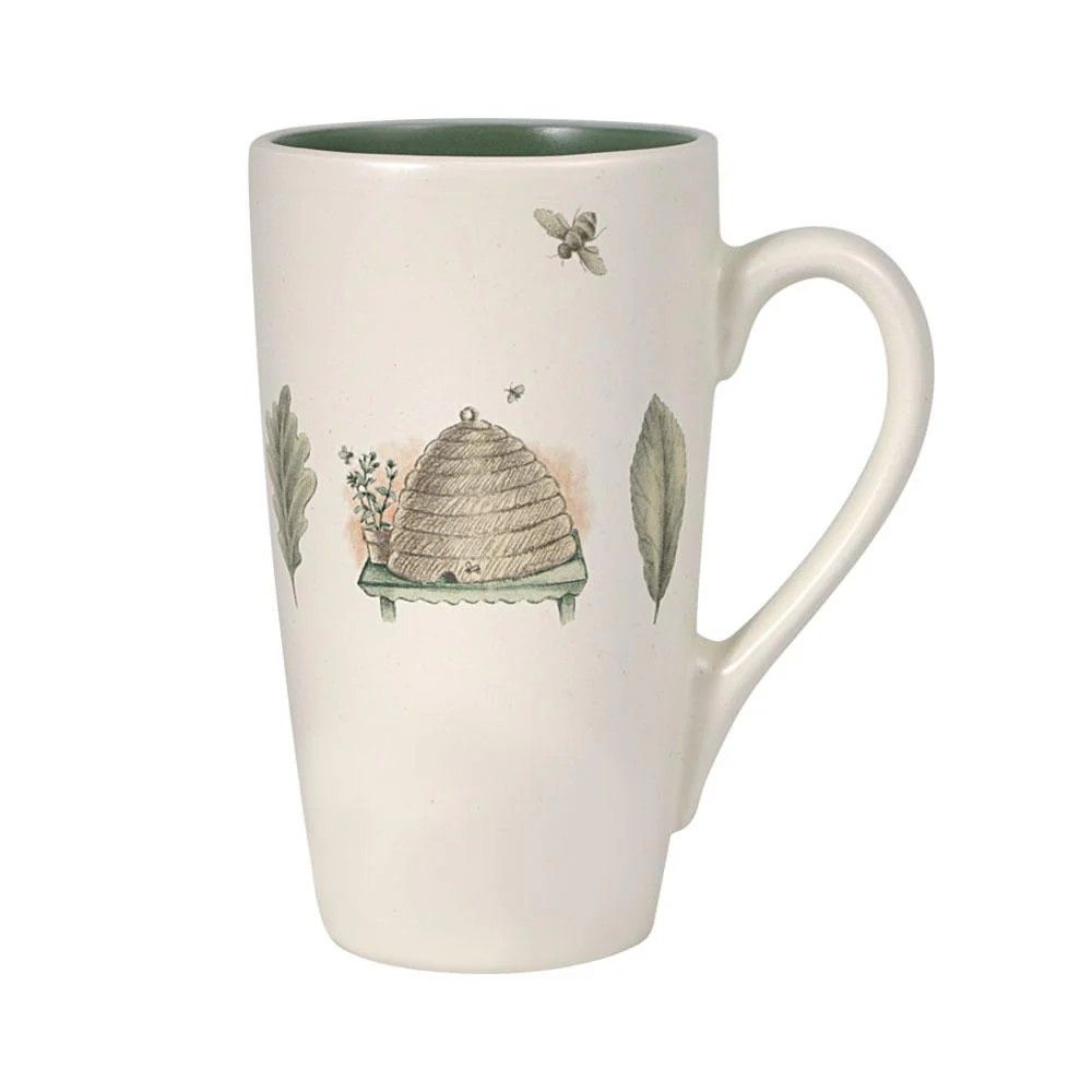 a tall coffee mug with beehive