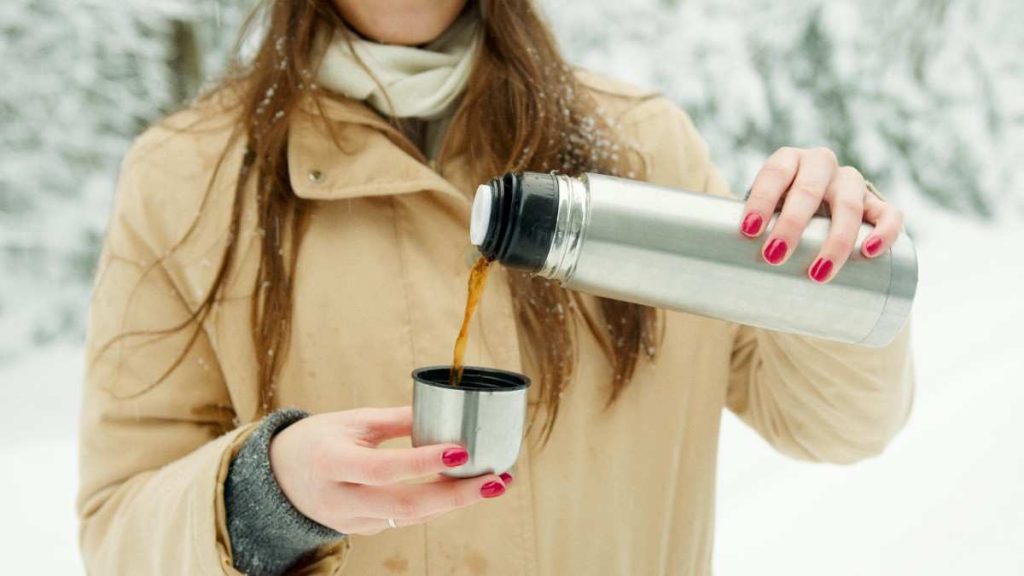 A person pouring coffee into a cup