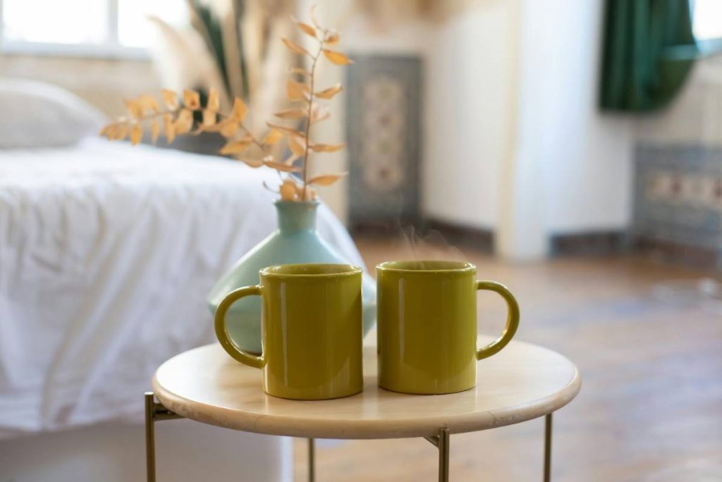 Two yellow coffee mugs on a table