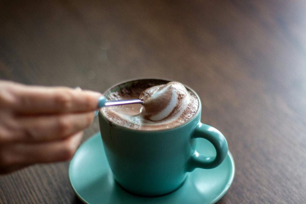 A person stirring a drink