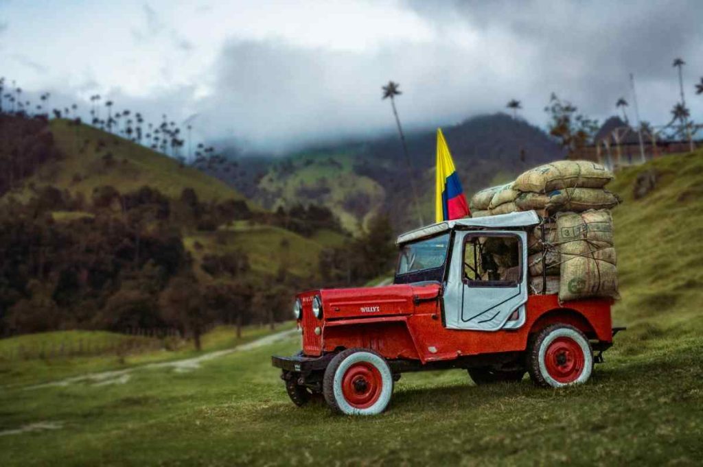 A red jeep with bags on top of it