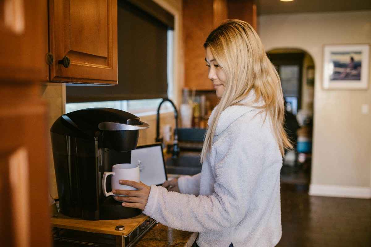 woman pouring a cup of coffee
