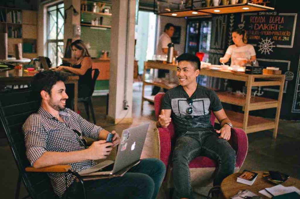 friends smiling in a coffee shop