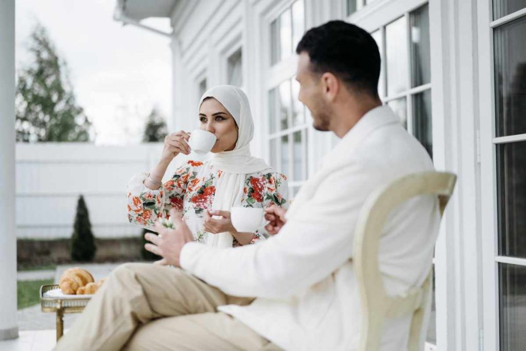 a couple sipping coffee outdoors