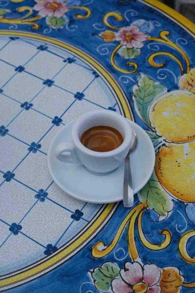 cup of coffee on blue white and yellow table