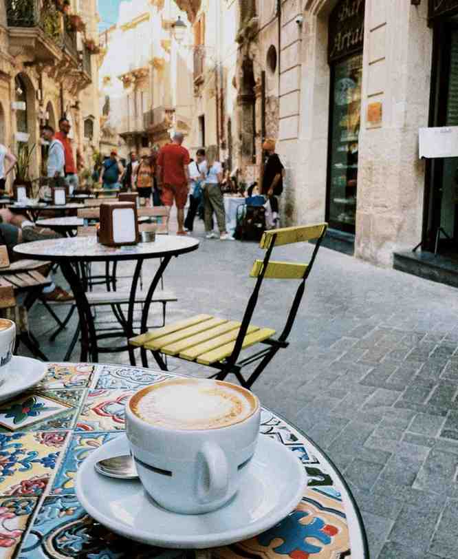 cup of coffee on table at outdoor cafe