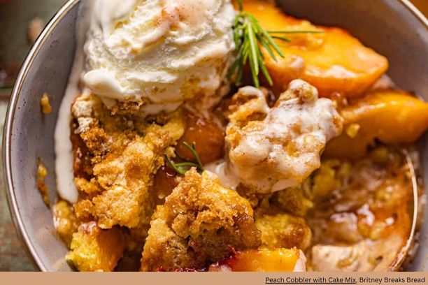 A close up of peach cobbler with a scoop of ice cream