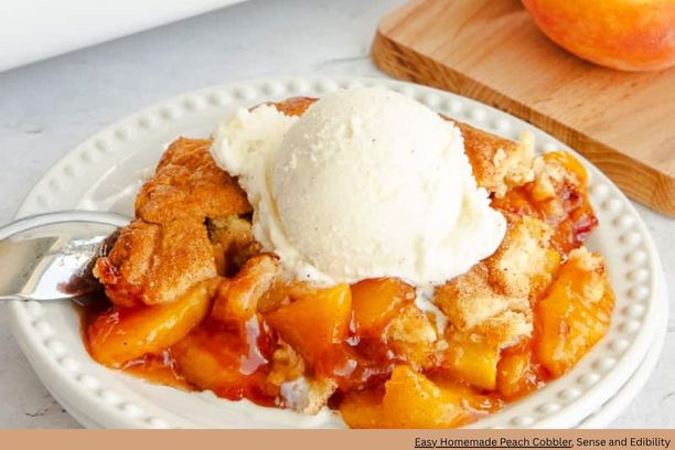 A plate of peach cobbler with a golden crust and a scoop of ice cream