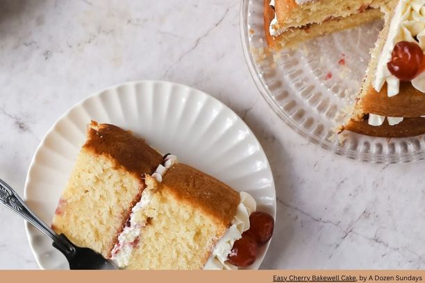 slice of cherry cake with whipped cream on a plate