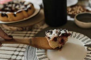 a slice of cherry cake resting on a cake server