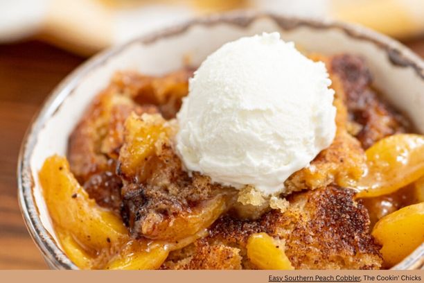 A bowl of peach cobbler with a scoop of ice cream