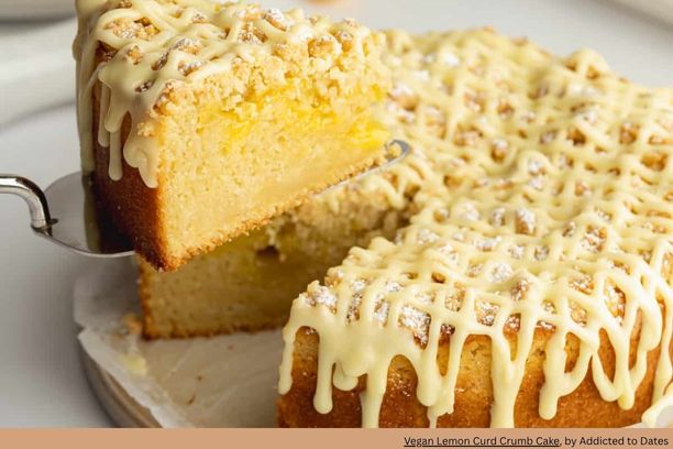 slice of lemon coffee cake on a cake server with drizzles of lemon glaze on top