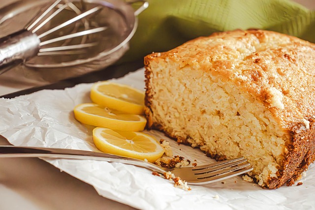 a lemon pound cake with 3 slices of lemons next to a fork
