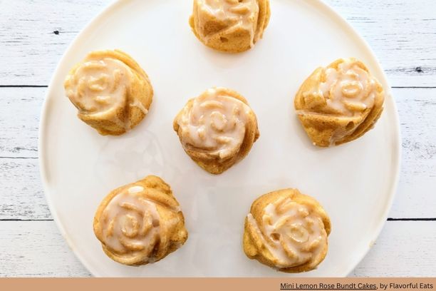 6 small yellow bundt cakes in the shape of a rose with a light glaze