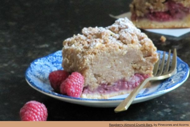 a slice of raspberry coffee cake on a small plate with a fork beside it