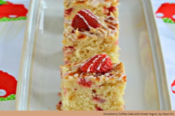 A piece of cake with strawberries and white glaze on top