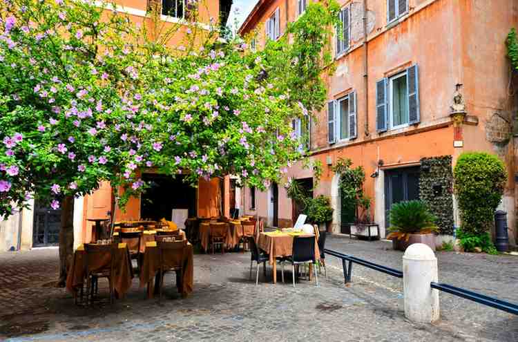 cafe setting in rome italy with trees and cobble stoned path